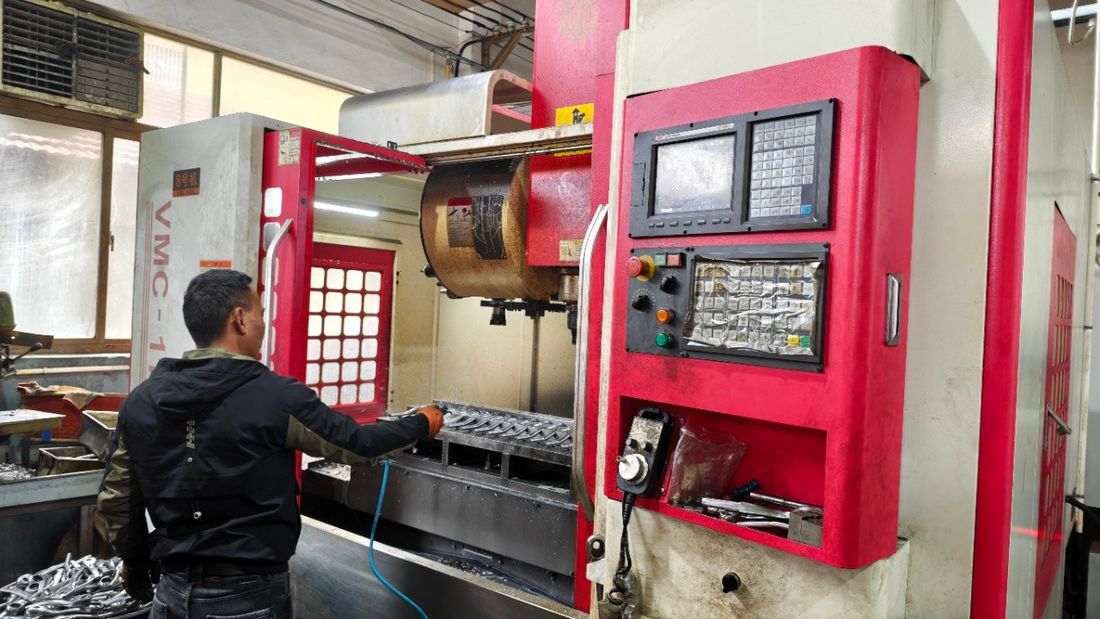 Operator loading a vertical machining centre